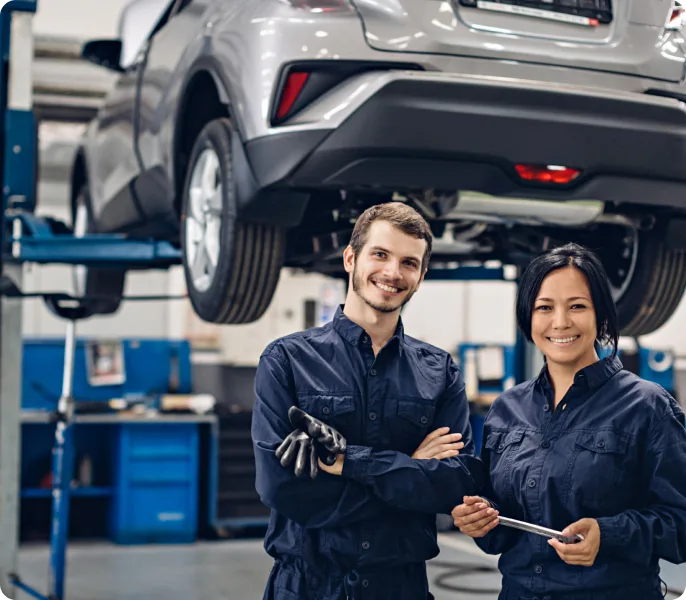 Mechanics inspecting a car